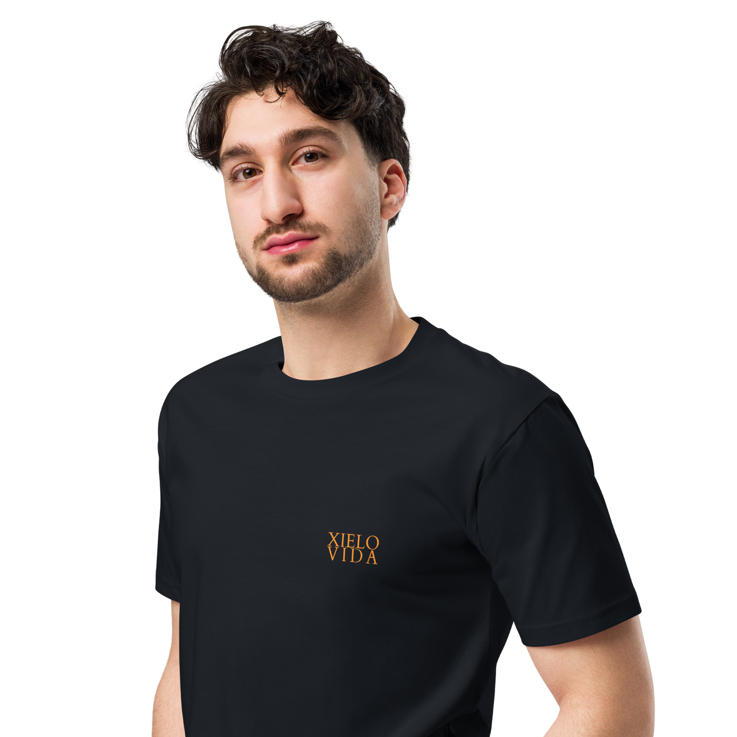 Male model wearing a navy premium mens t-shirt with the Xielo Vida logo in small gold lettering on the left chest.